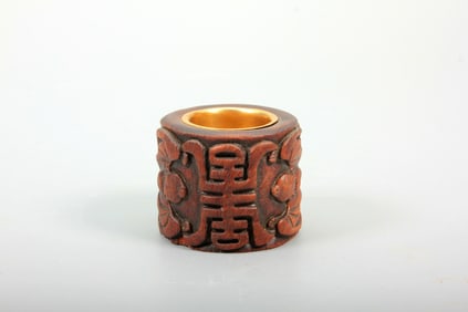 AN AGARWOOD ARCHER'S RING CARVED WITH 'FU SHOU' MOTIF