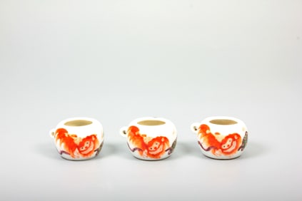 A SET OF FAMILLE-ROSE BIRD-FEEDERS WITH LION AND BALL DESIGN