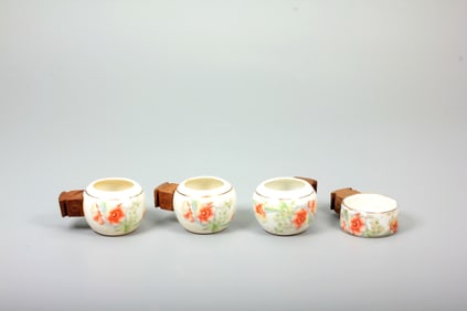 A SET OF BIRD-FEEDERS WITH FLORAL DECORATION