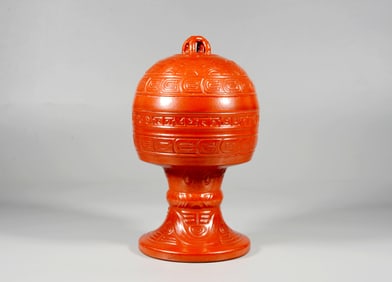 A LACQUER-LIKE CARVED PORCELAIN STEM CUP