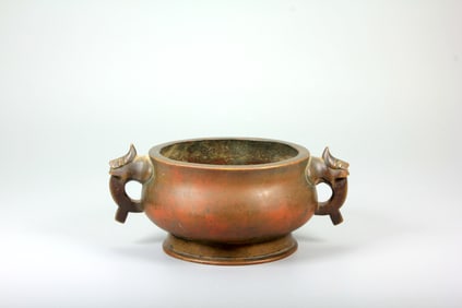 A BRONZE BURNER WITH 'DRAGON'HANDLES