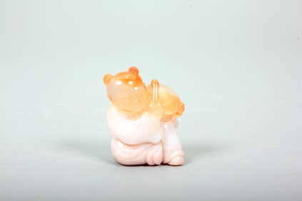 A NANHONG AGATE CARVING OF DRUM-BEATING CHILD