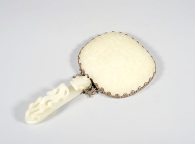 A BRONZE MIRROR INLAID WITH JADE