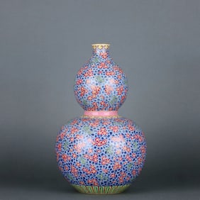 A FAMILLE ROSE "BAMBOO AND PLUM" DOUBLE-GOURD VASE