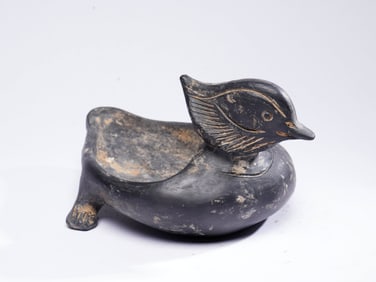A BLACK POTTERY DUCK