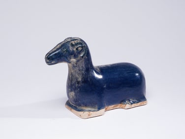 A BLUE-GLAZED RECLINING RAM