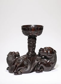 A Zitan Carved 'Auspicious Beasts' Candlestick