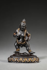 A Tibetan Iron and Gold Figure of Black Jambhala