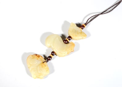 A Celadon and White Jade "Skin-Retained" Bead Strand