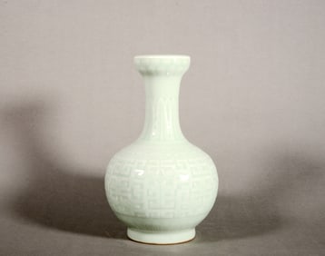 A Pea Green Glazed Molded Kui Dragon Vase