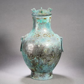 A BRONZE EWER WITH SILVER INLAY