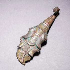 A BRONZE BELT HOOK WITH GOLD INLAY