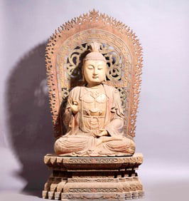 A WOODEN STATUE OF SHAKYAMUNI