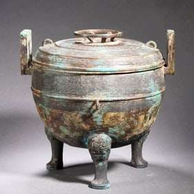 A BRONZE TRIPOD DING