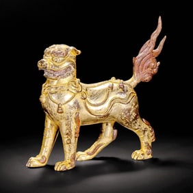 A GILT-BRONZE BEAST STATUE