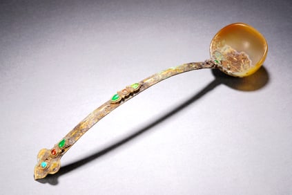 A GILT-BRONZE SPOON