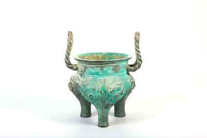 A BRONZE 'BEAST MASK' TRIPOD LI VESSEL