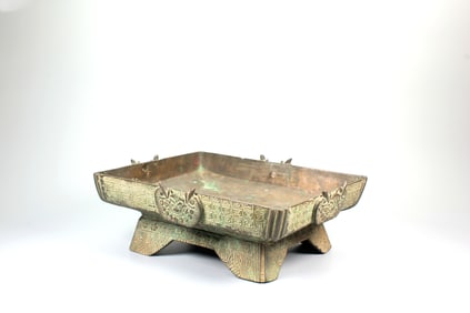 A BRONZE 'BEAST MASK' SQUARE DISH
