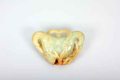 A HETIAN JADE 'WATER CALTROP' CARVING