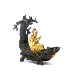 A GILT-BRONZE FIGURE OF IMMORTAL ON A BOAT
