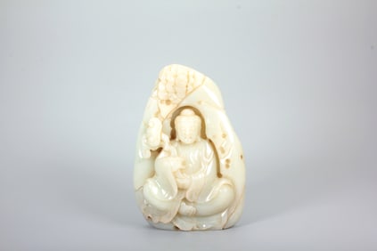 A HETIAN JADE FIGURE OF GUANYIN IN A GROTTO