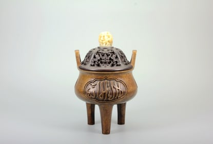 A TRIPOD ARABIC-INSCRIBED BRONZE CENSER WITH DOUBLE HANDLES