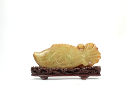 A JADE FISH PLAYING LEAF