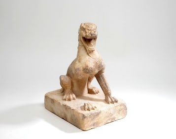 A STONE CARVING OF A LION