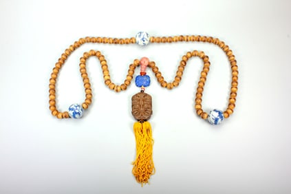 AN AGARWOOD COURT NECKLACE WITH PORCELAIN 'DRAGON' BEADS