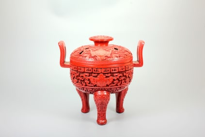 A CARVED CINNABAR LACQUER 'BEAST'TRIPOD CENSER