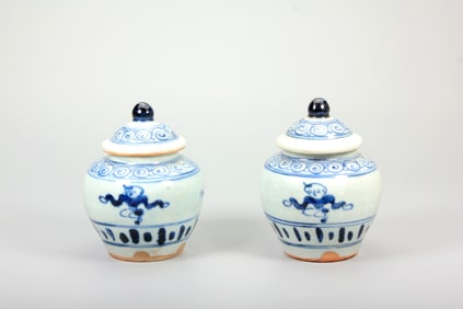 A PAIR OF BLUE AND WHITE 'BOYS'JARS AND COVERS