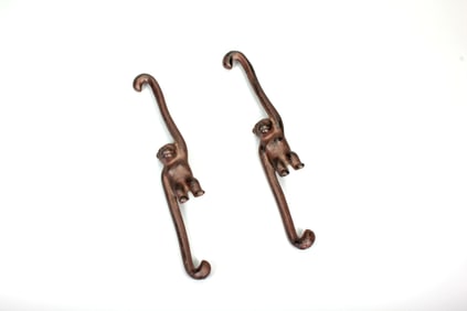 A PAIR OF IRON MONKEY ORNAMENTS