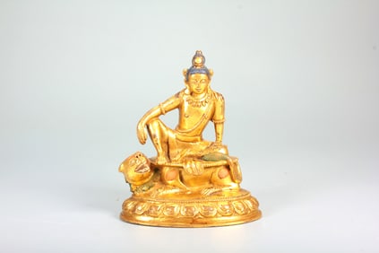 A GILT-BRONZE FIGURE OF GUANYIN IN FREE POSTURE