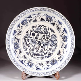 A LARGE BLUE-AND-WHITE PLATE WITH MANDARIN DUCKS PLAYING IN WATER