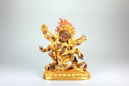 A GILT-BRONZE FIGURE OF SIX-ARMED MAHAKALA