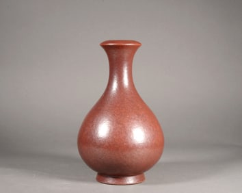 A IRON-RUST FLOWER VASE WITH FLARED MOUTH