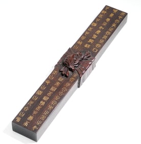 A ROSEWOOD PAPERWEIGHT ENGRAVED WITH POEM