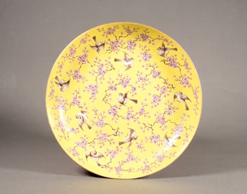 A YELLOW-GROUND FAMILLE ROSE FLOWER-AND-BIRD DISH