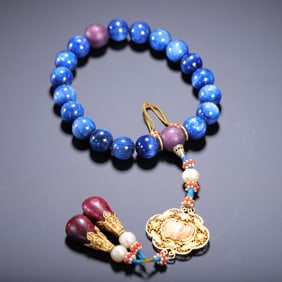 A LAPIS LAZULI EIGHTEEN-SEED HANDSTRING