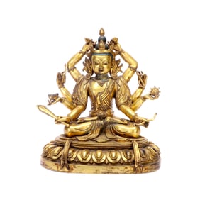 A GILT-BRONZE FIGURE OF EIGHT-ARMED GUANYIN