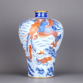 A BLUE-AND-WHITE AND IRON-RED "DRAGONS" PRUNUS VASE