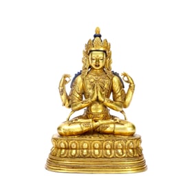 A GILT-BRONZE FIGURE OF FOUR-ARMED BUDDHA
