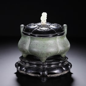 A BRONZE TRIPOD CENSER