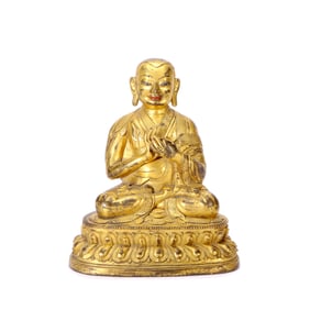 A GILT-BRONZE FIGURE OF GURU