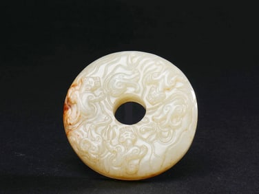 A HETIAN JADE BI (DISK) WITH DRAGON PATTERNS