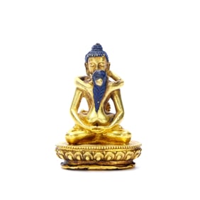 A GILT-BRONZE FIGURE OF YAB-YUM BUDDHA