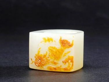 A HETIAN JADE RING (BANZHI) CARVED WITH FISH-TRANSFORMING-INTO-DRAGON PATTERN