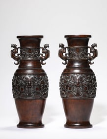 A Pair of Carved Wood 'Taotie' Bottle Vases