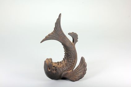 A FISH-TURNS-DRAGON BRONZE PAPERWEIGHT