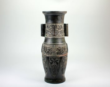 A BEAST-MASK HANDLED BRONZE VASE